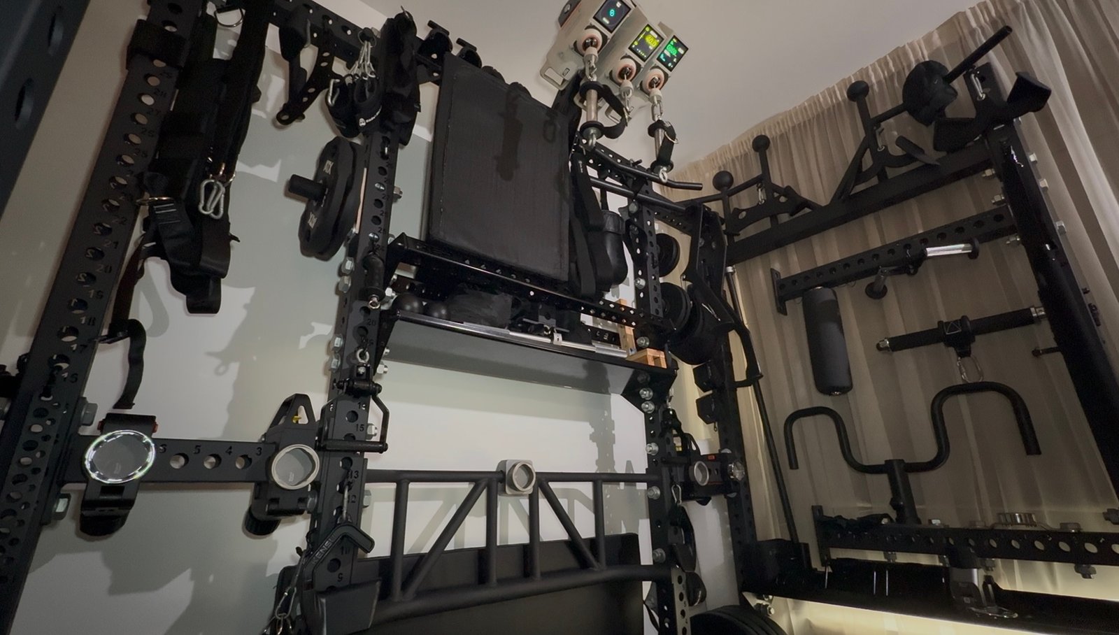 Mind Muscle Perfection home gym with REP power rack, mounted VOLTRA cable resistance units and training attachments