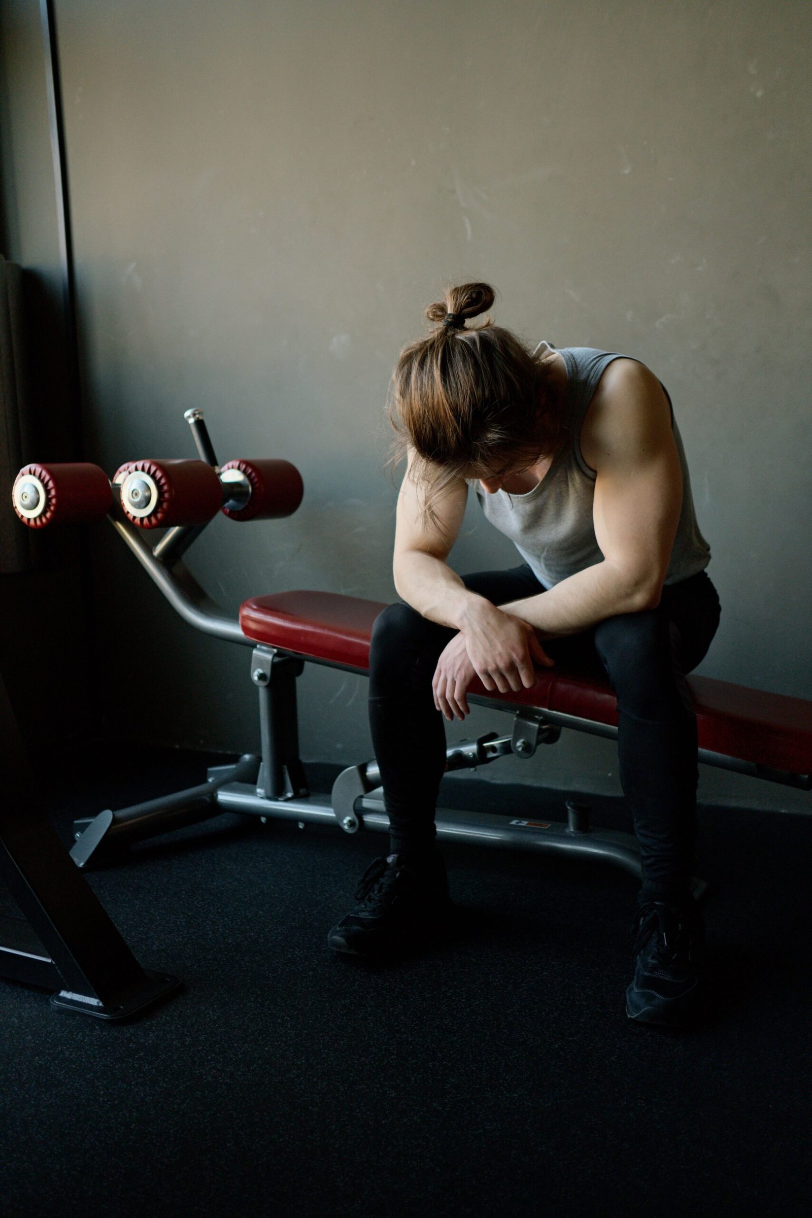 Athlete resting on a bench after lifting weights