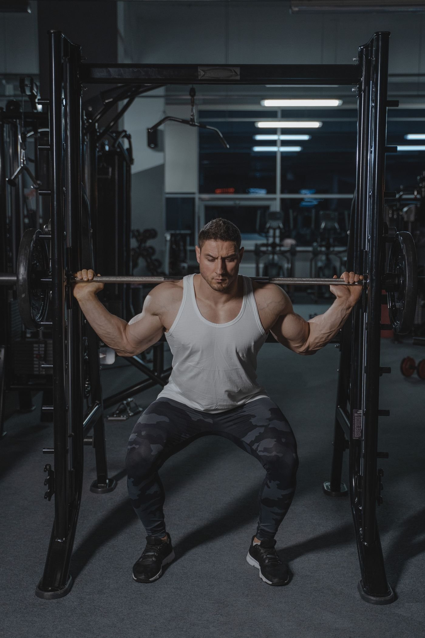 Lifter performing a barbell squat in a gym