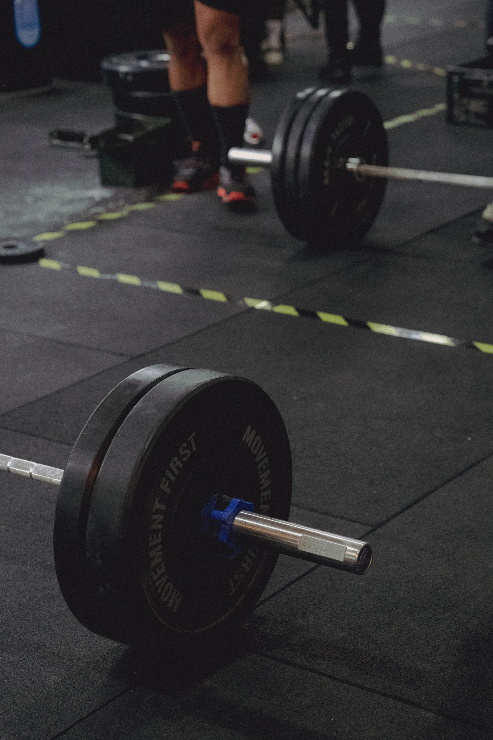 Olympic barbell and bumper plates prepared for a strength workout