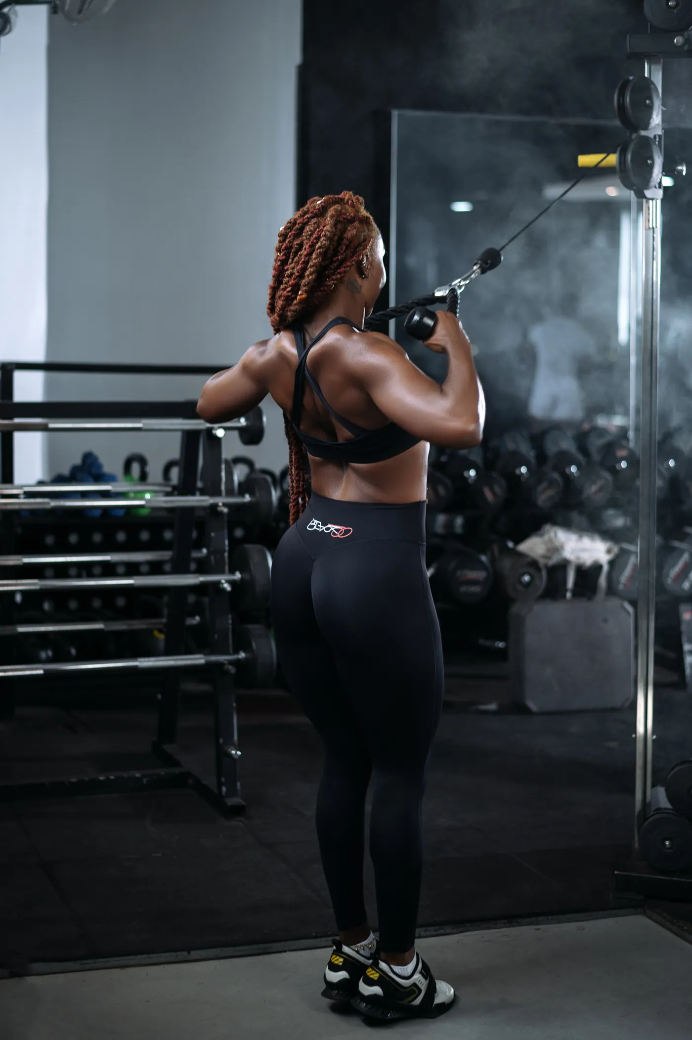 Woman performing resistance training in a modern gym