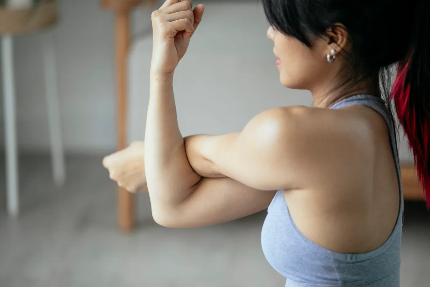 Woman stretching her arm to illustrate post-exercise mobility