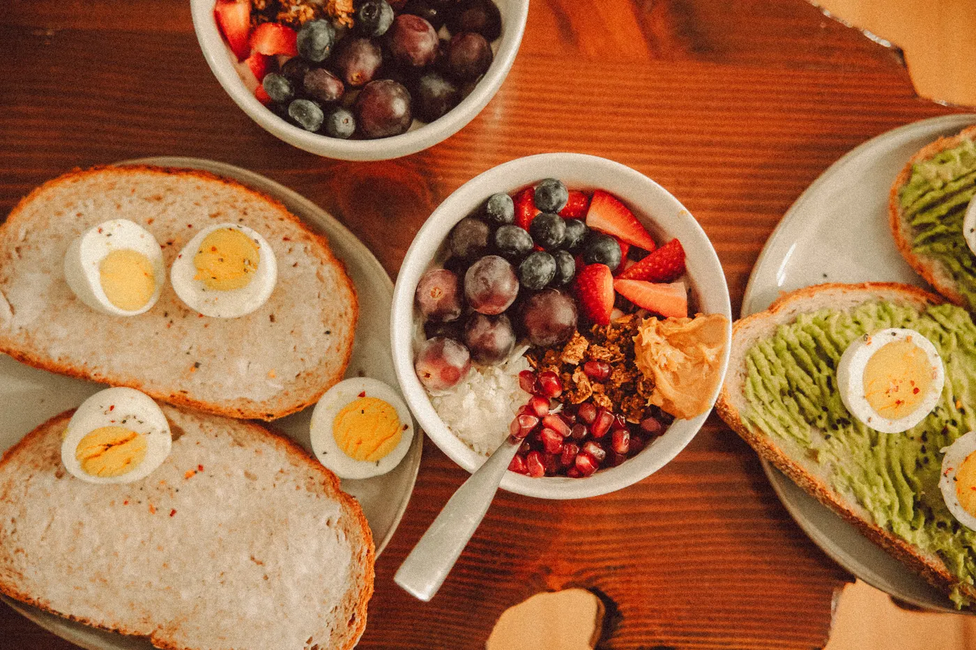High-protein breakfast with yogurt, eggs, avocado and toast