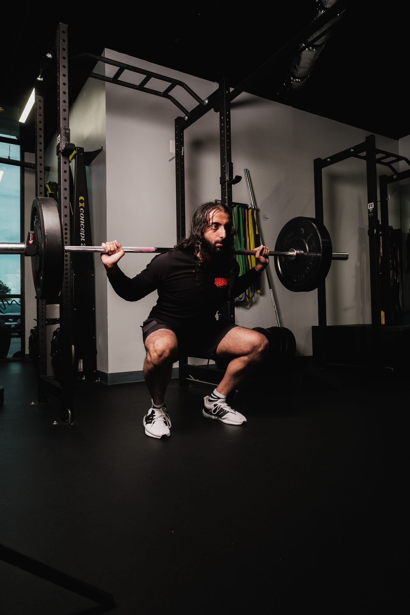 Athlete squatting with a barbell in a gym