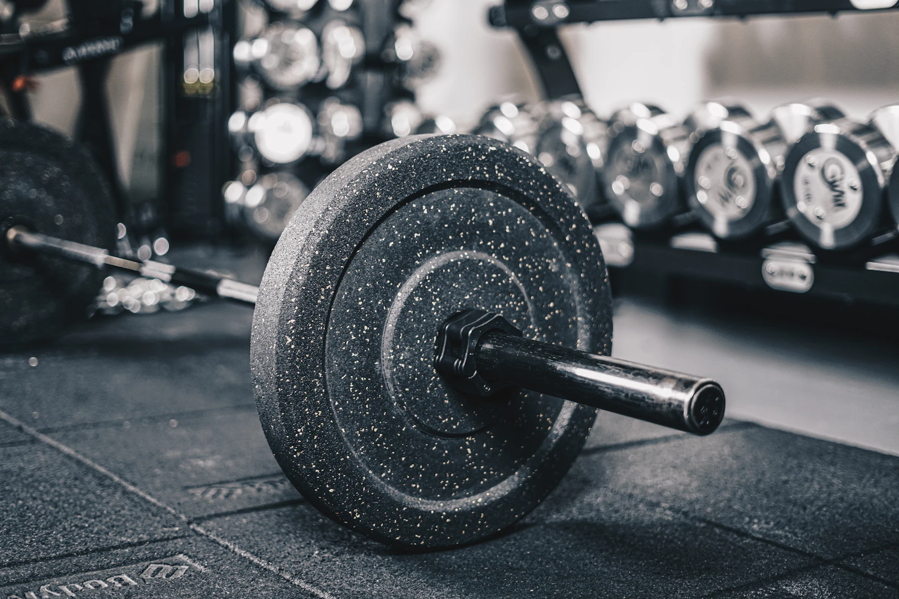 Loaded barbell and free weights in a strength-training area