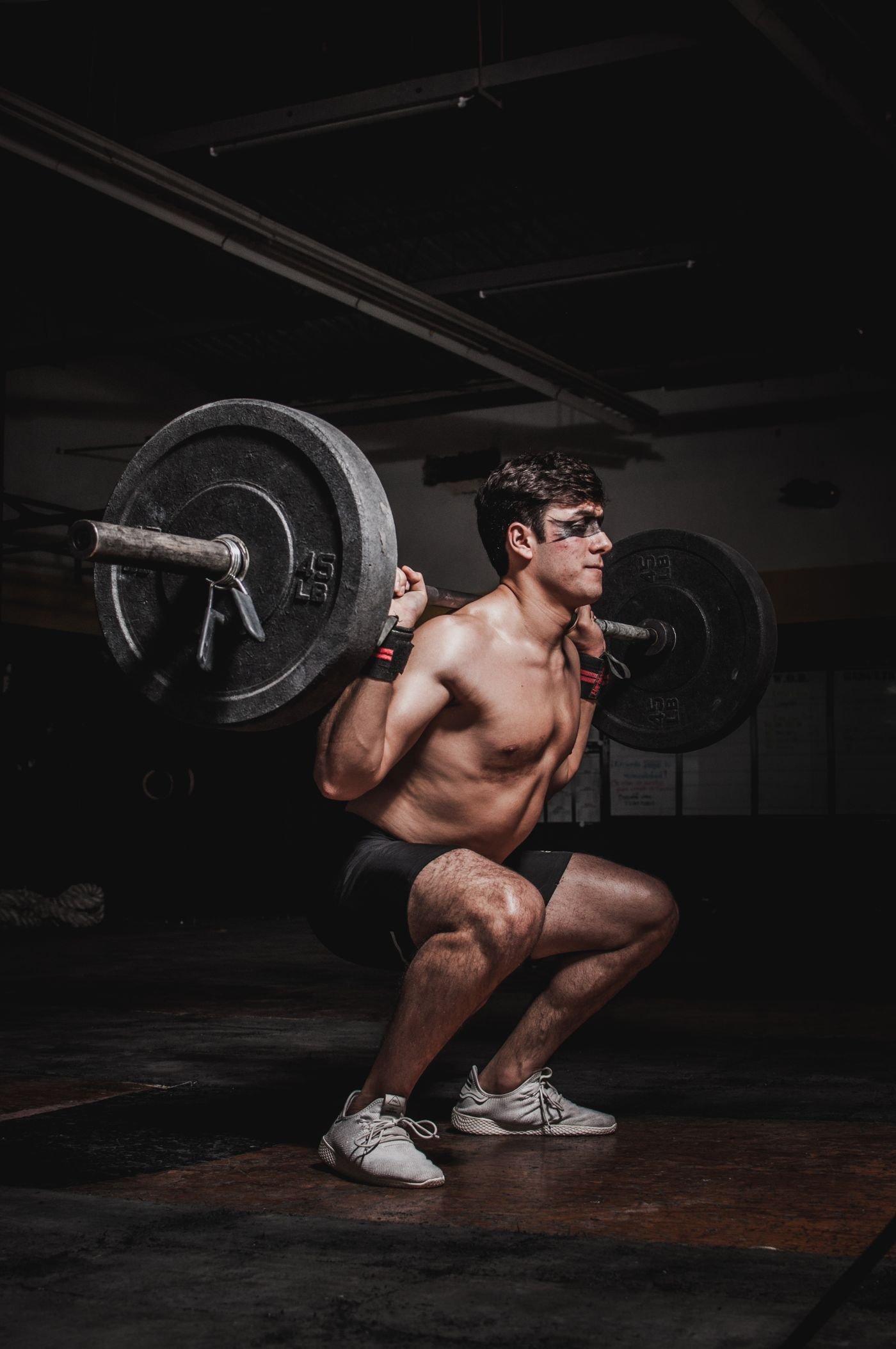 Man lifting a barbell during resistance training in a gym