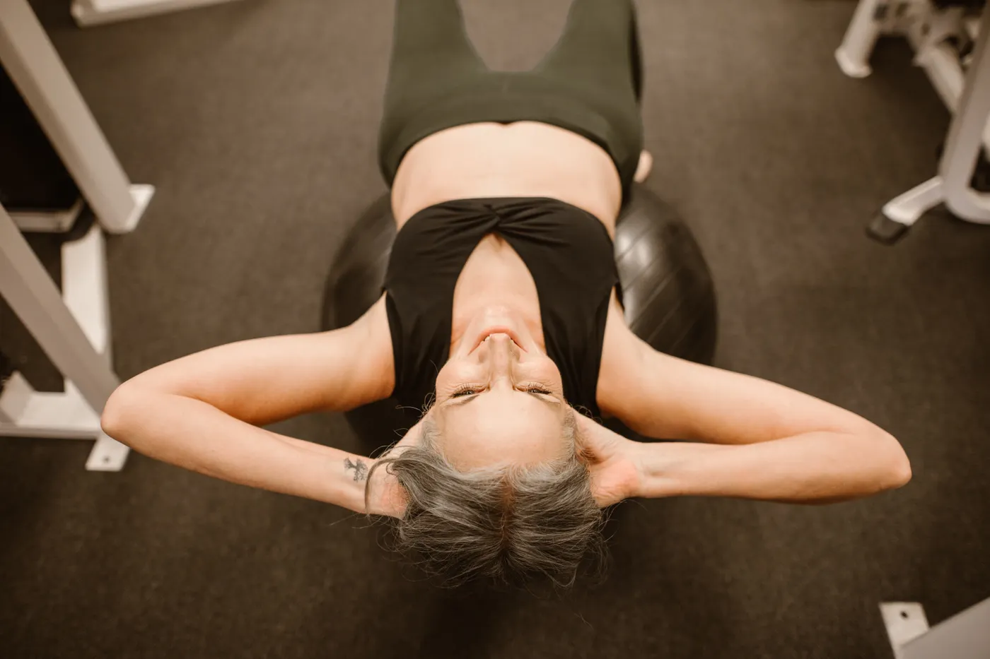 Senior woman using a stability ball for controlled strength exercise
