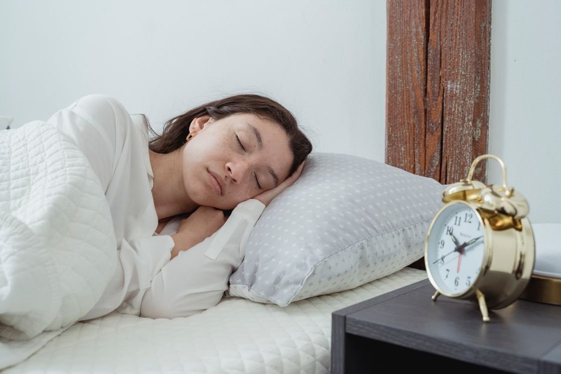 Woman sleeping in bed, highlighting recovery and rest