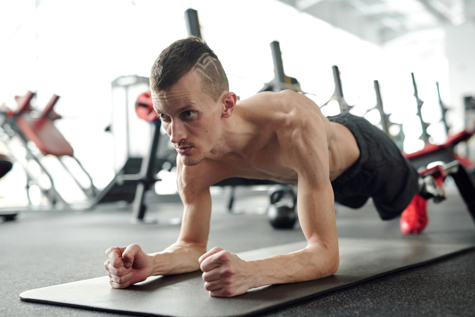 Athlete holding a plank on an exercise mat