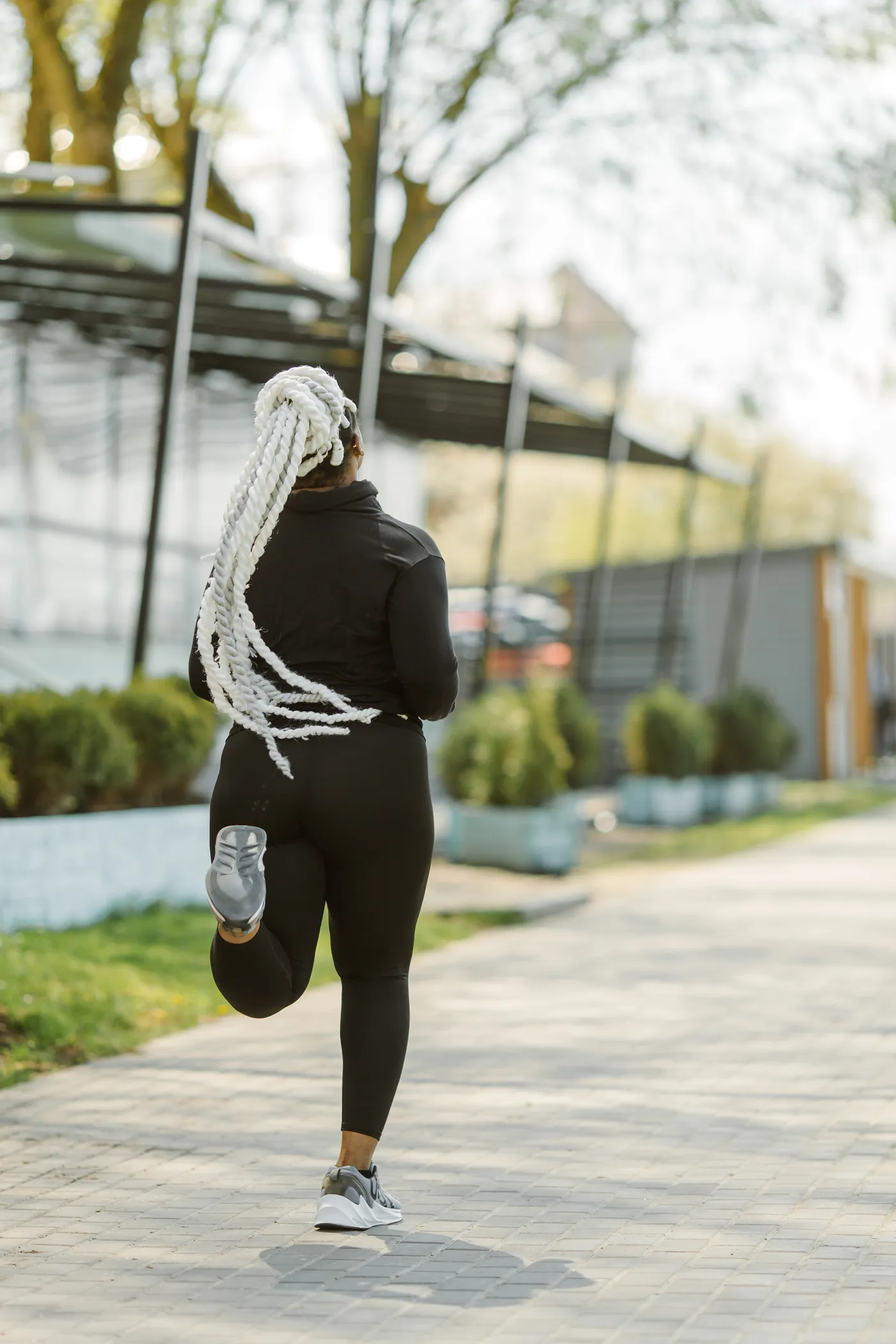 Rear view of a woman running through a park