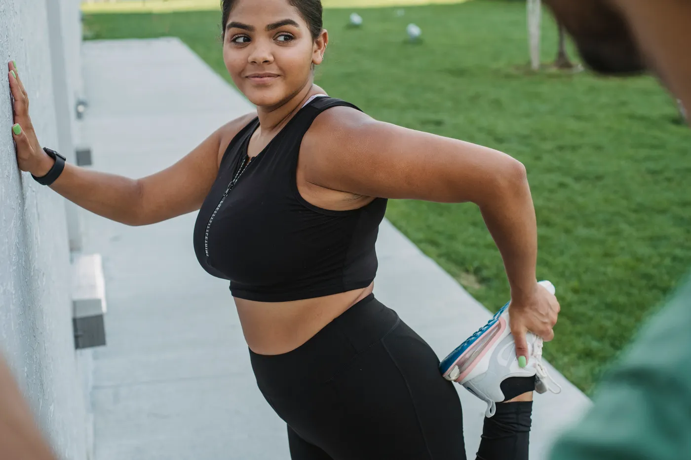 Woman stretching her leg after exercise outdoors