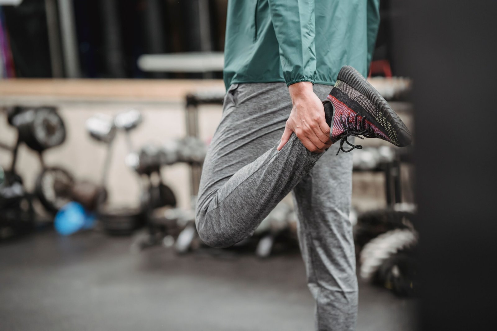 Man stretching his quadriceps in a gym before exercise