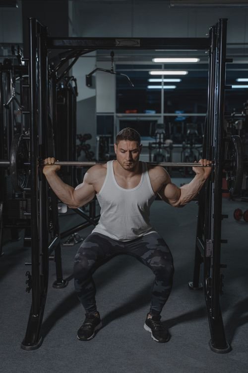 Man performing a controlled barbell squat