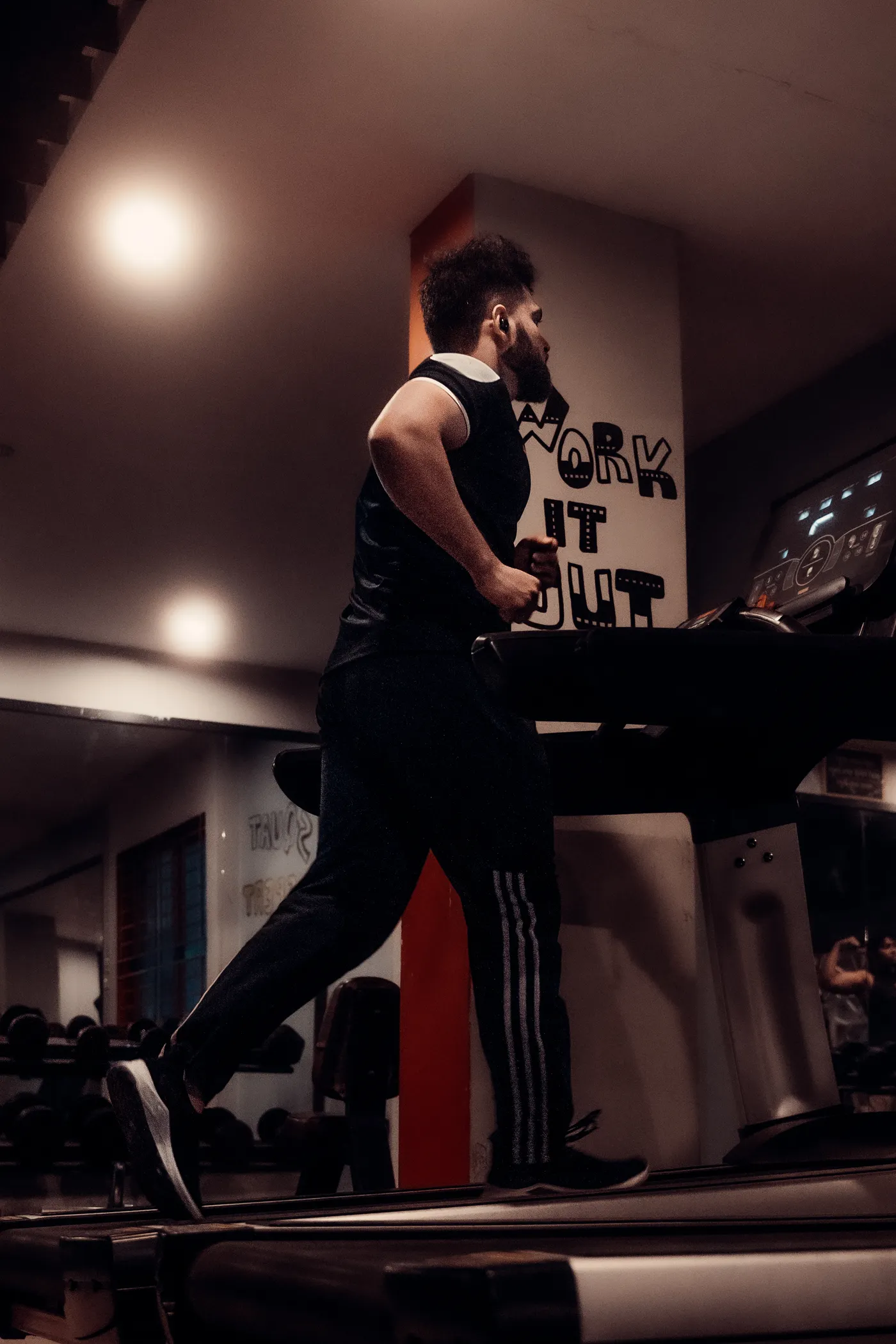 Runner exercising on a treadmill in a gym