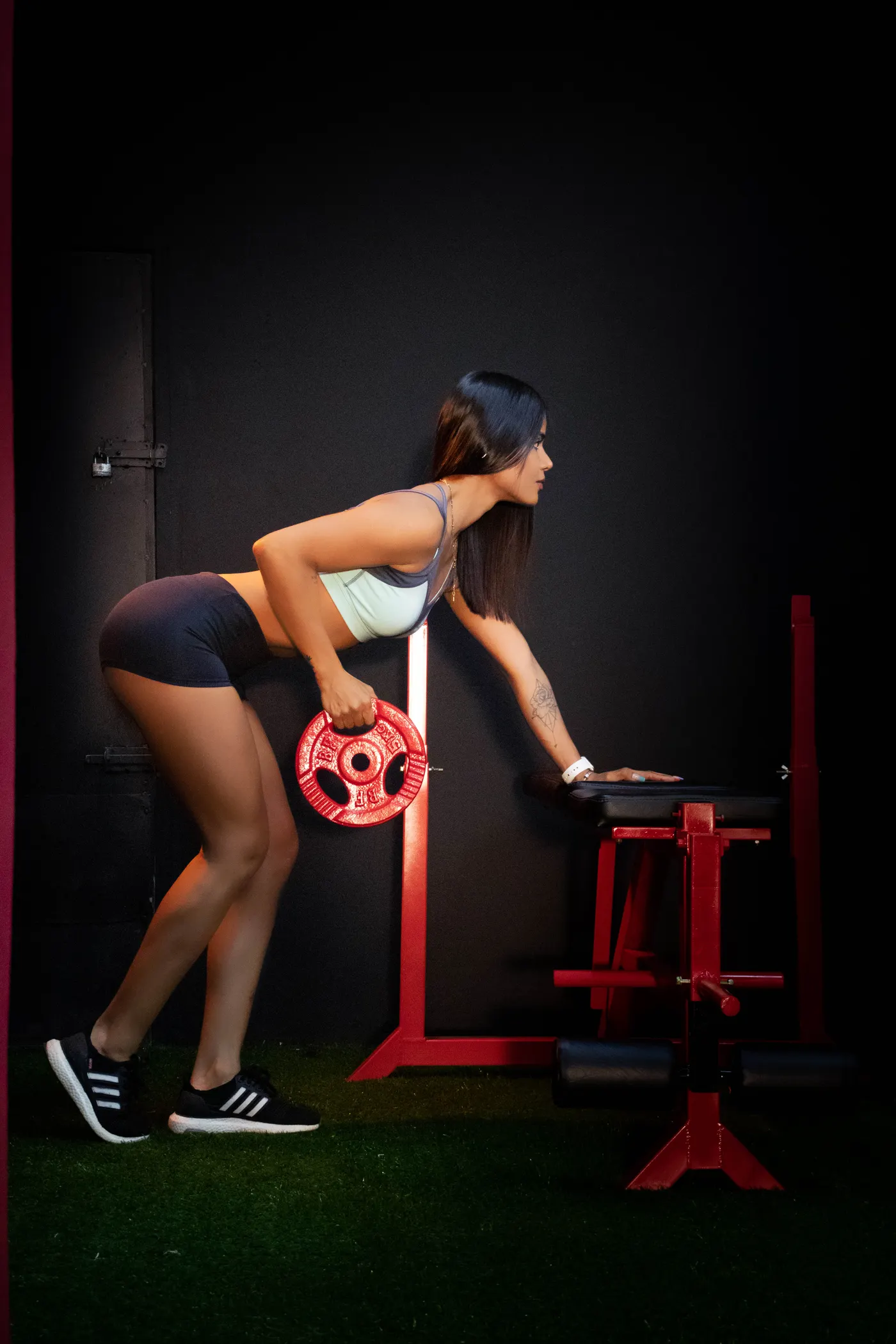 Woman exercising with a weight plate in a gym