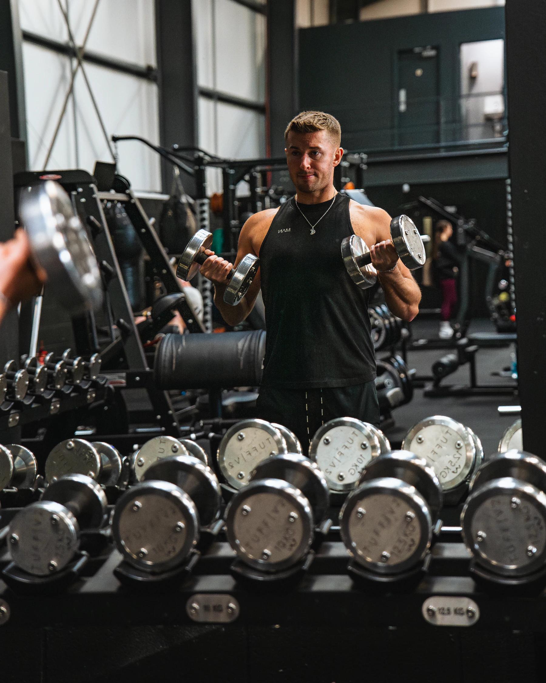 Athlete performing dumbbell curls during resistance training