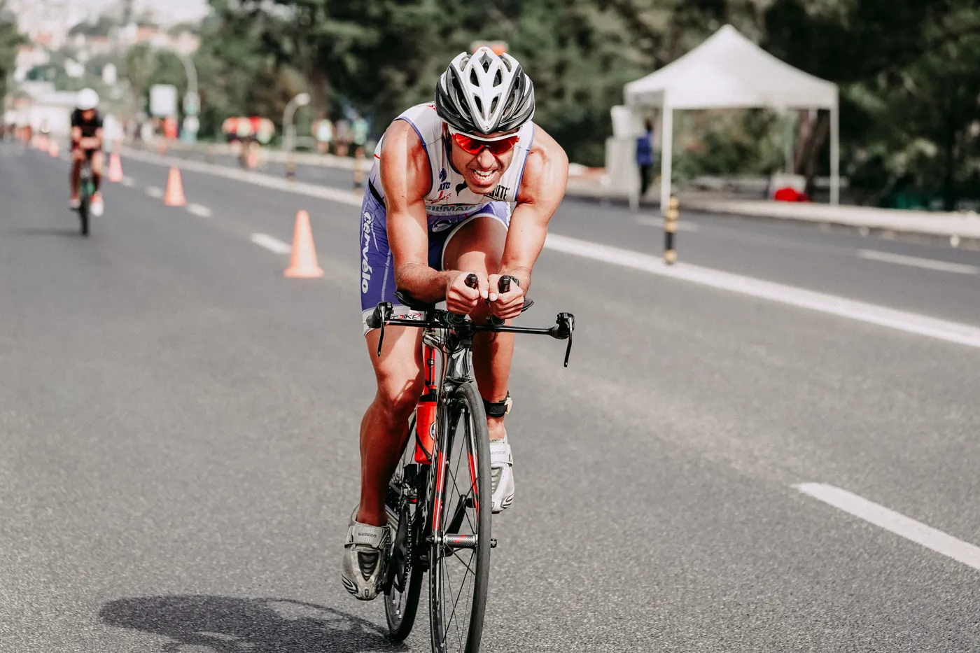 Road cyclist accelerating during a high-effort ride