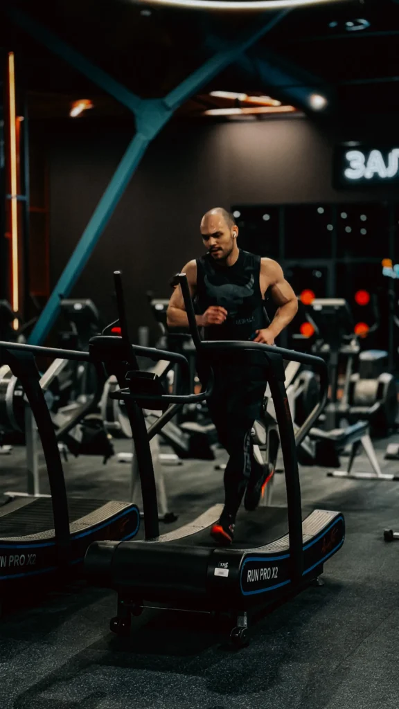 Focused runner training on a treadmill in a modern gym