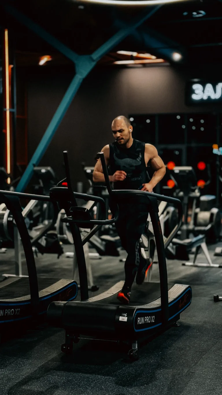 Focused runner training on a treadmill in a modern gym