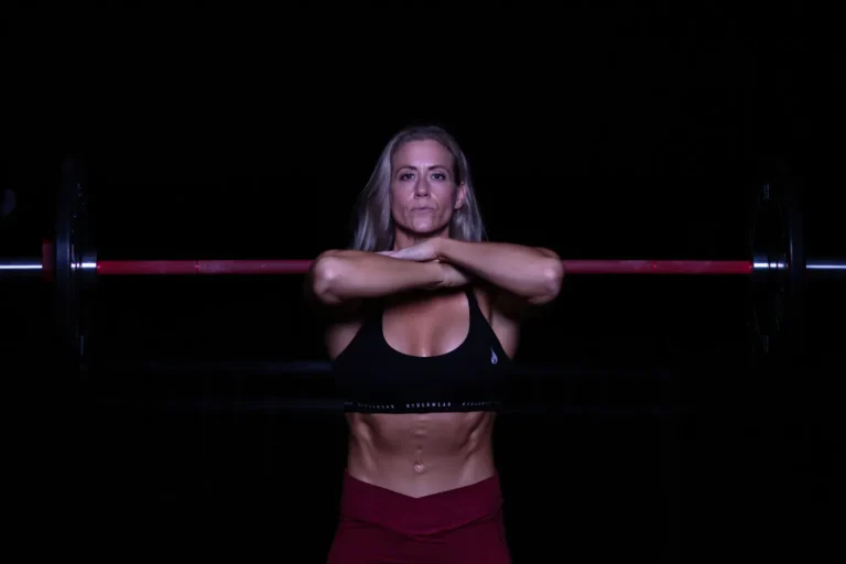 Woman lifting a barbell in a strength-training gym