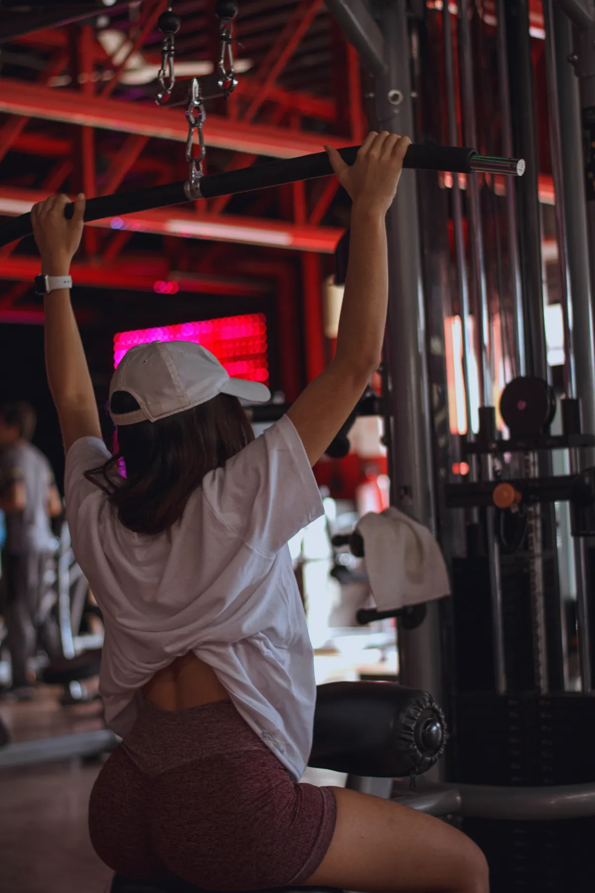 Woman performing a seated pulldown with controlled posture