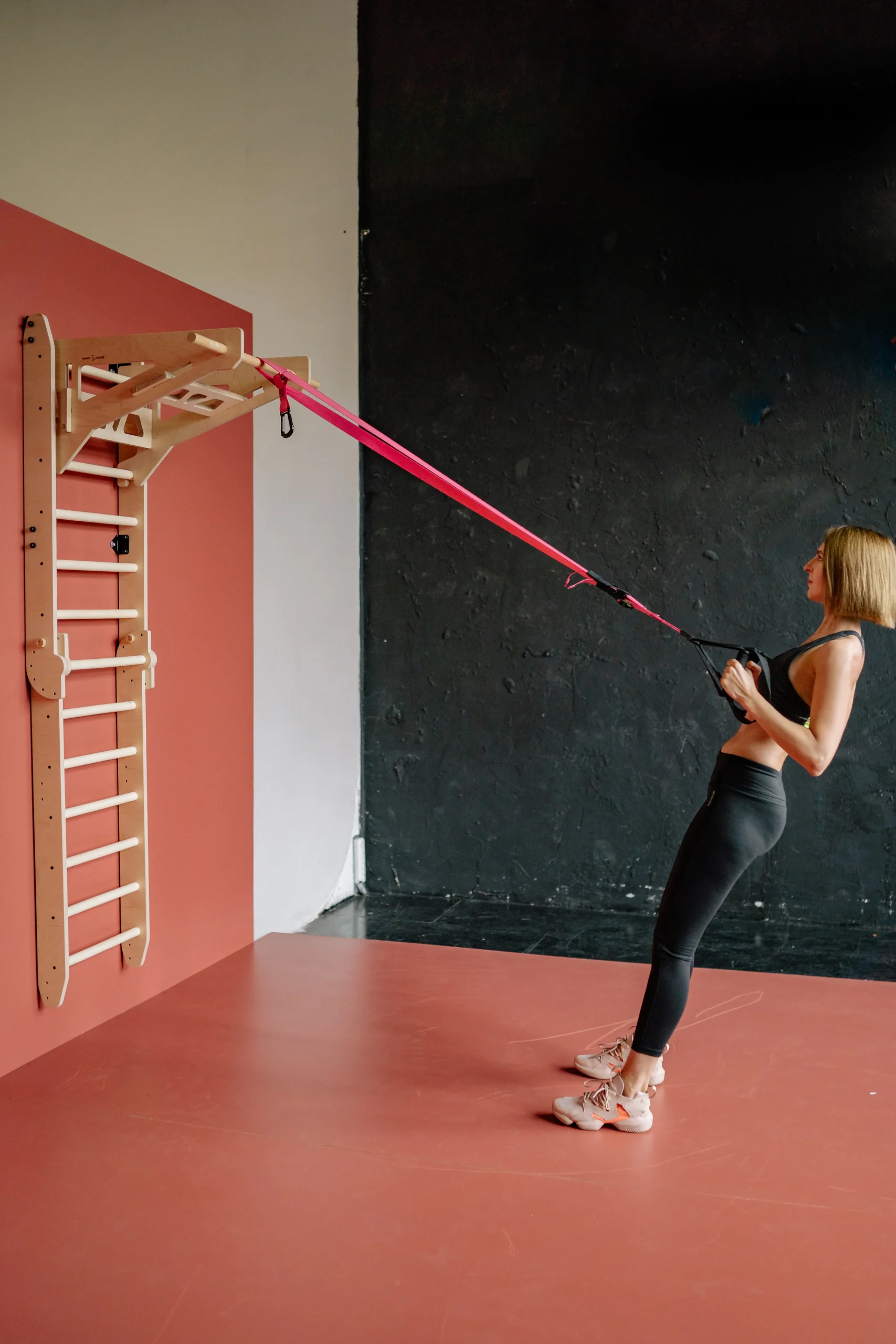Woman using resistance bands attached to exercise equipment