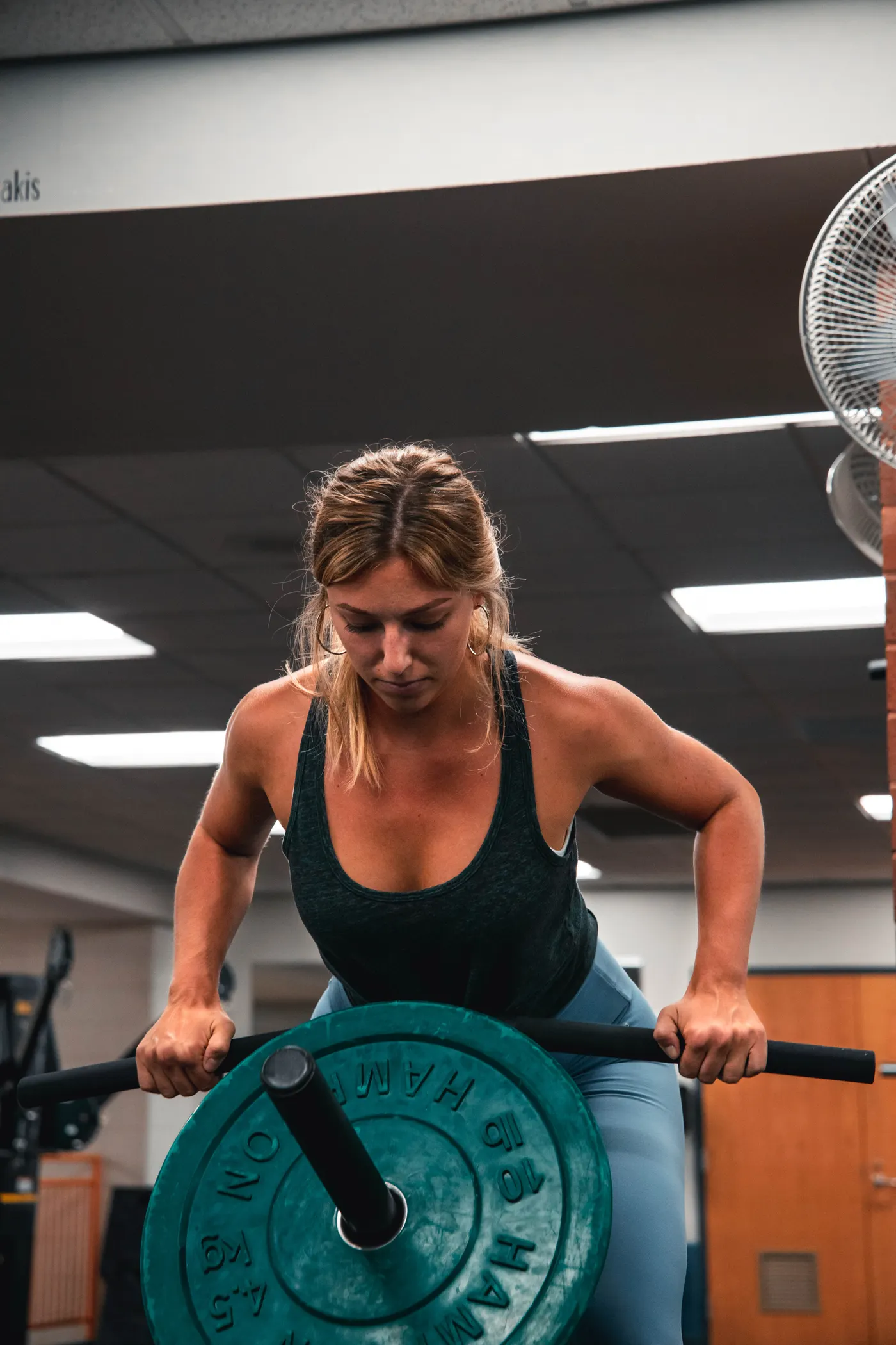 Woman lifting a barbell in gym