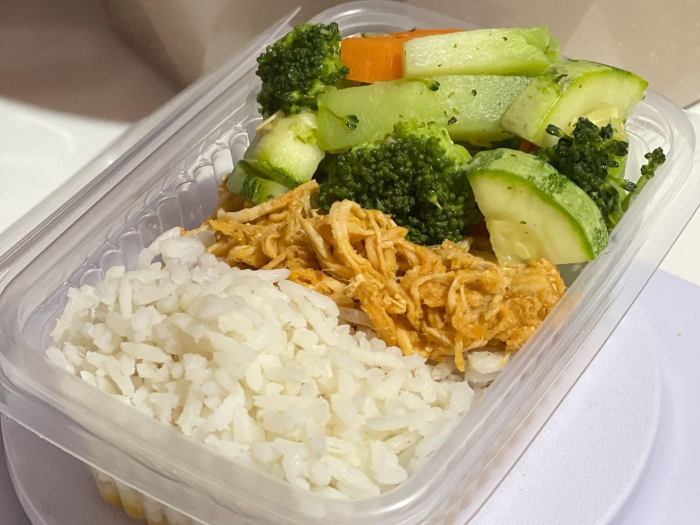 Prepared chicken, rice and vegetables in a lunch box, illustrating meal planning