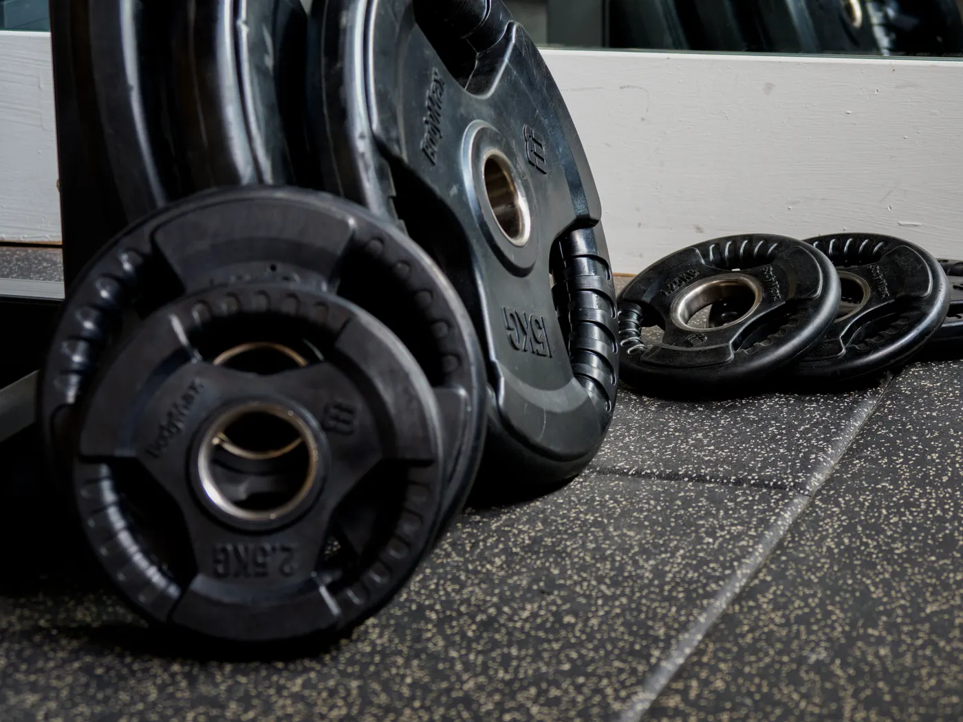 Close-up of stacked weight plates for changing resistance loads