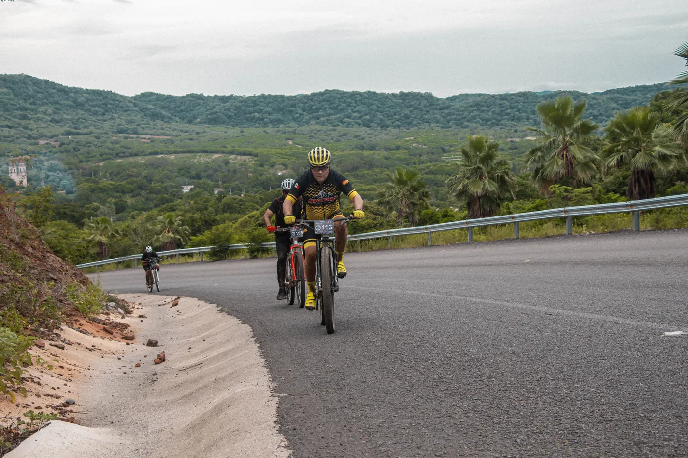 Cyclists climbing a steep road together during a race