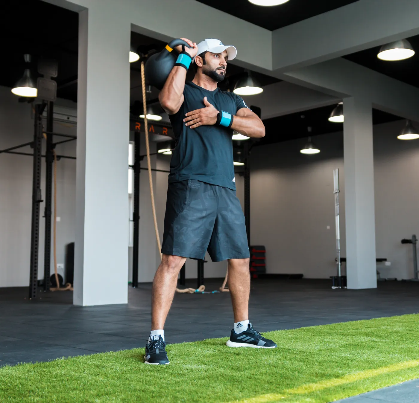 Man exercising with a kettlebell in a fitness center