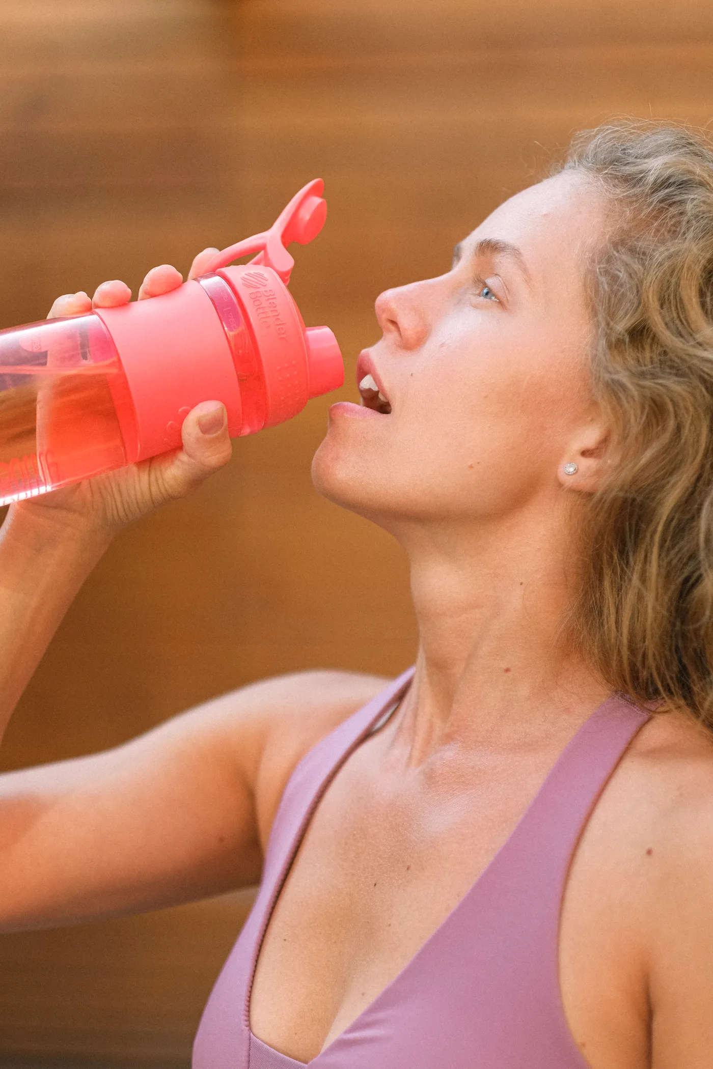 Runner drinking from a reusable bottle after exercise
