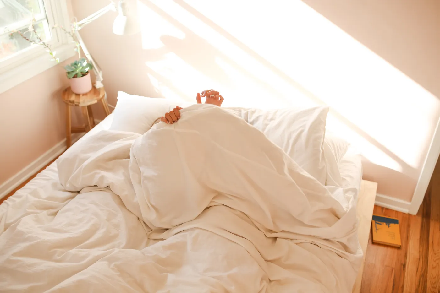 Person resting in bed, illustrating sleep beyond a device recovery score