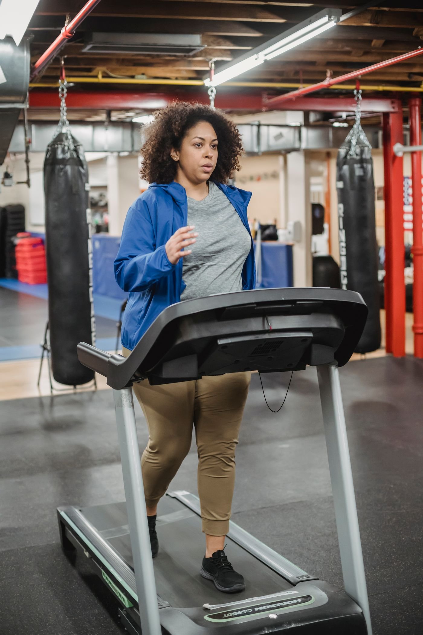 Woman running on a treadmill in a gym