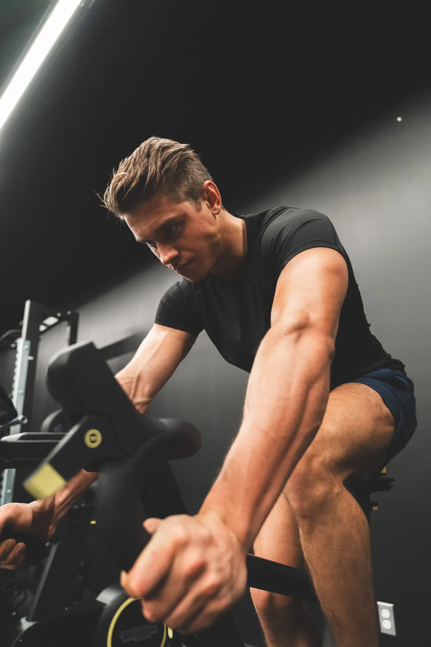 Athlete cycling intensely on an indoor exercise bike