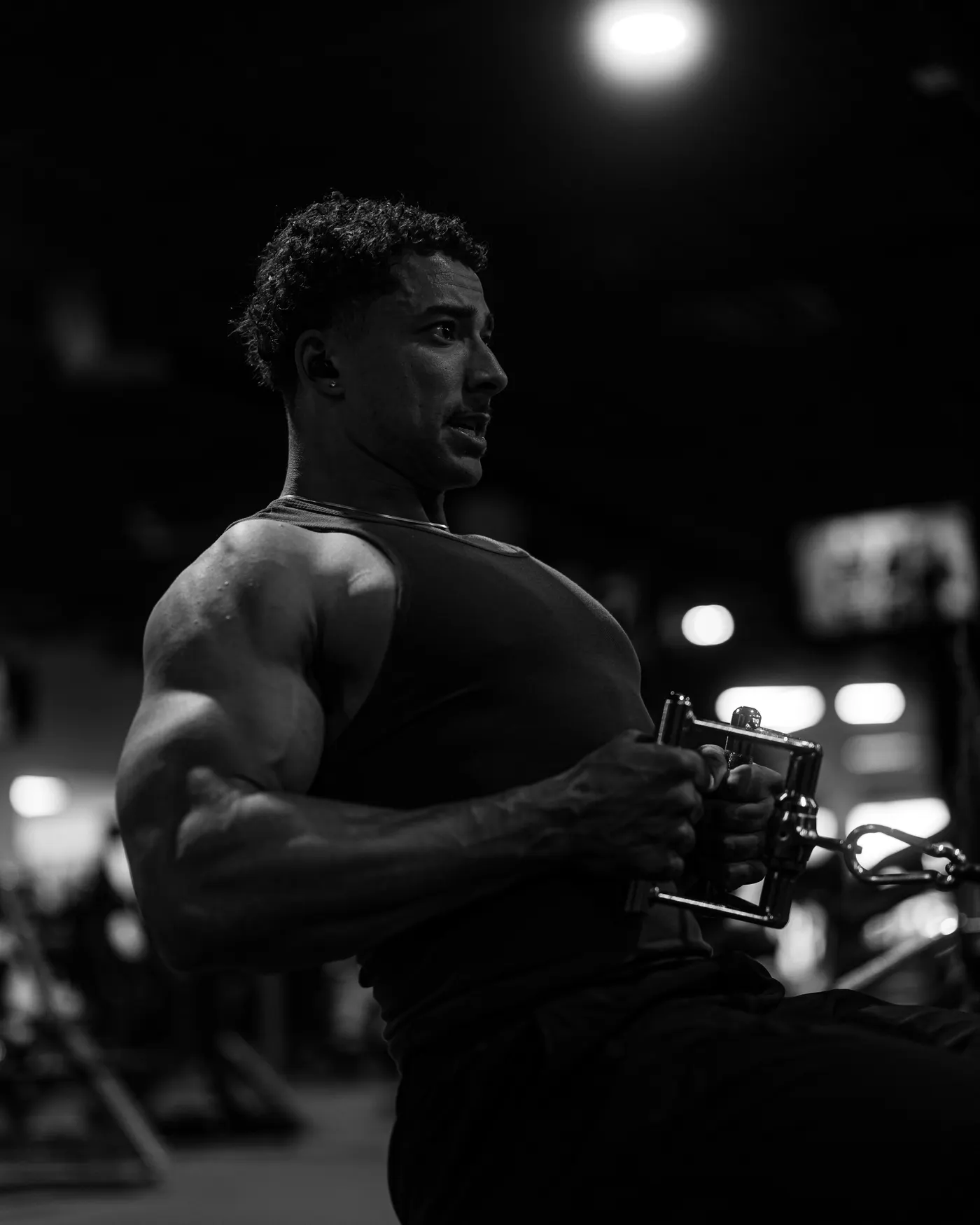 Athlete working against resistance on a gym cable machine