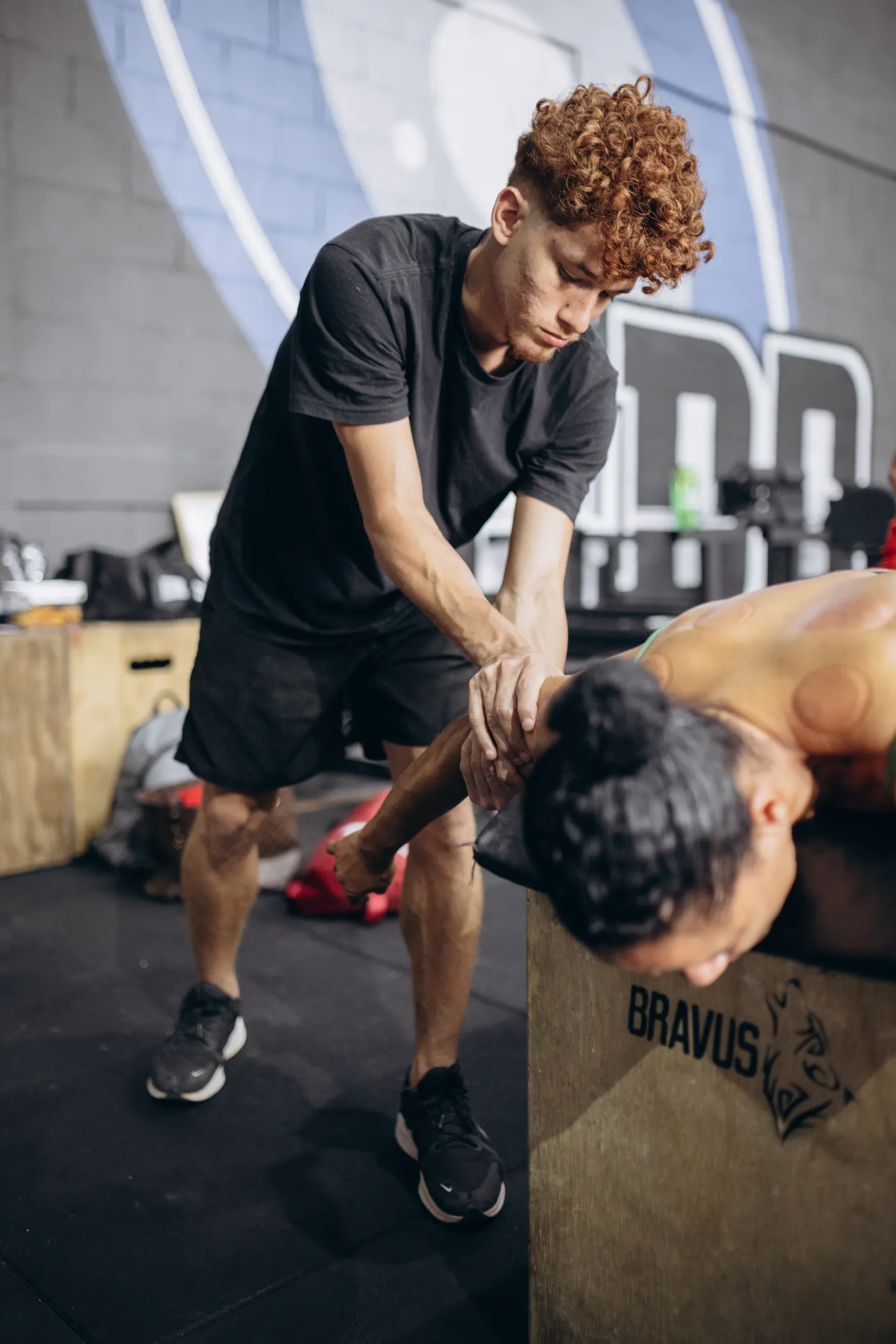 Trainer assisting a shoulder mobility drill