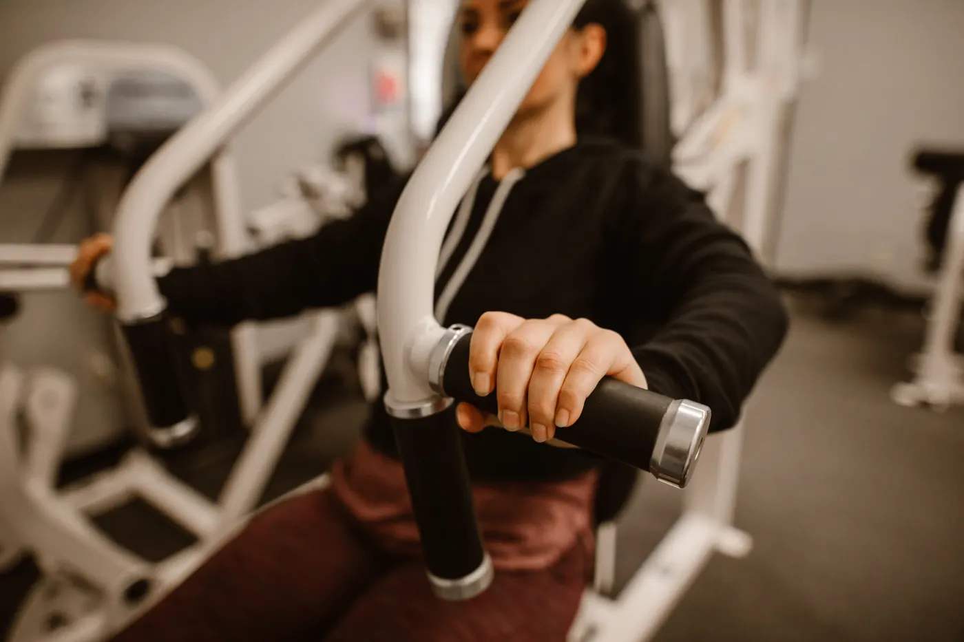 Woman using a seated chest press machine
