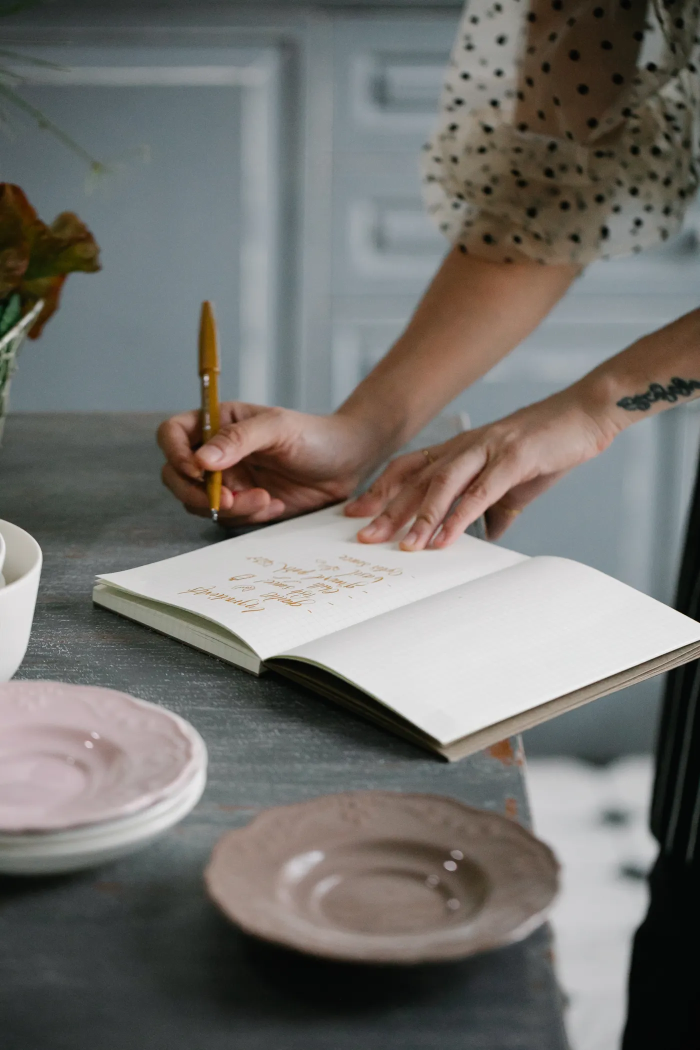 Woman writing in a notebook beside food, illustrating a diet decision checklist
