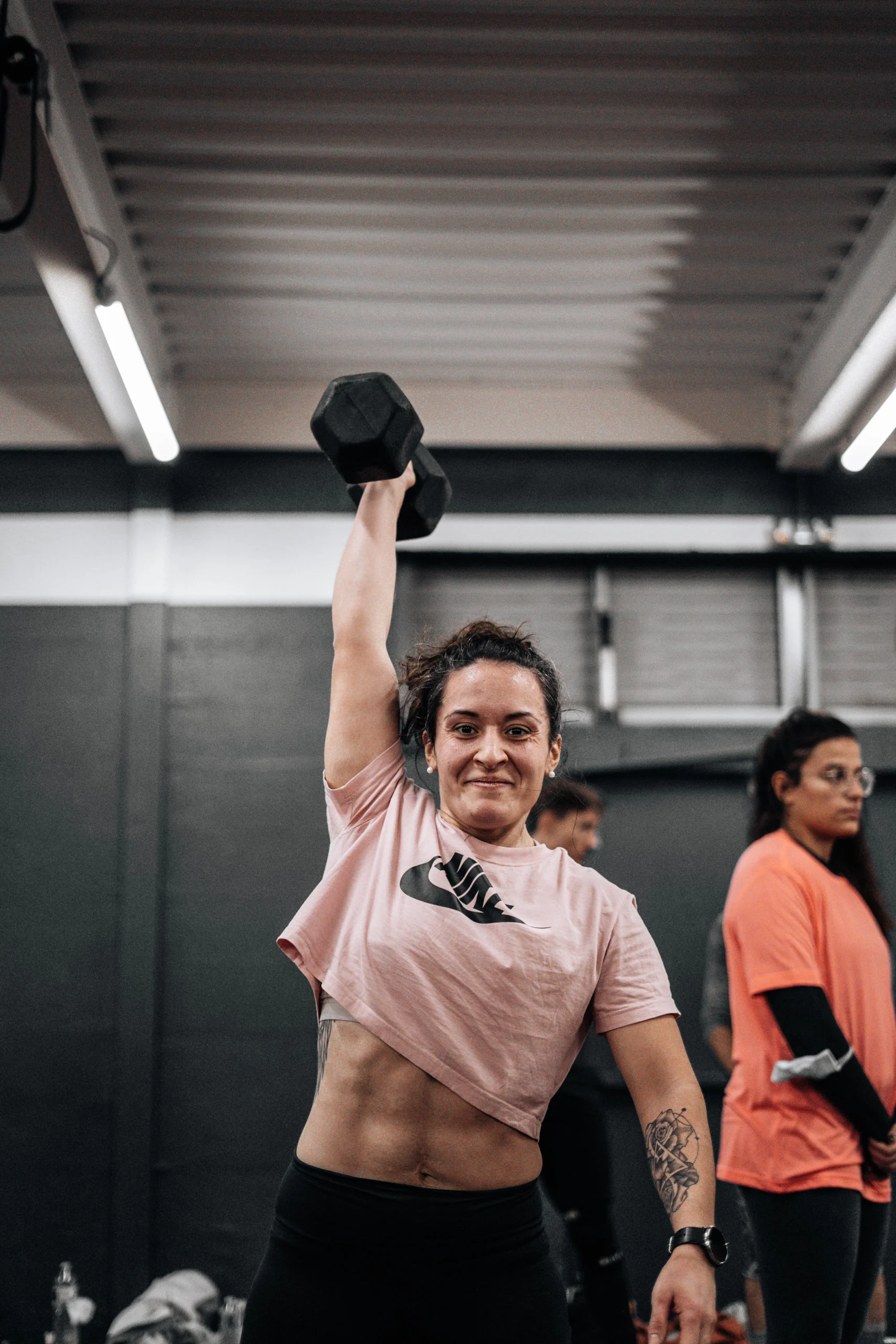 Woman lifting a dumbbell during a gym strength session