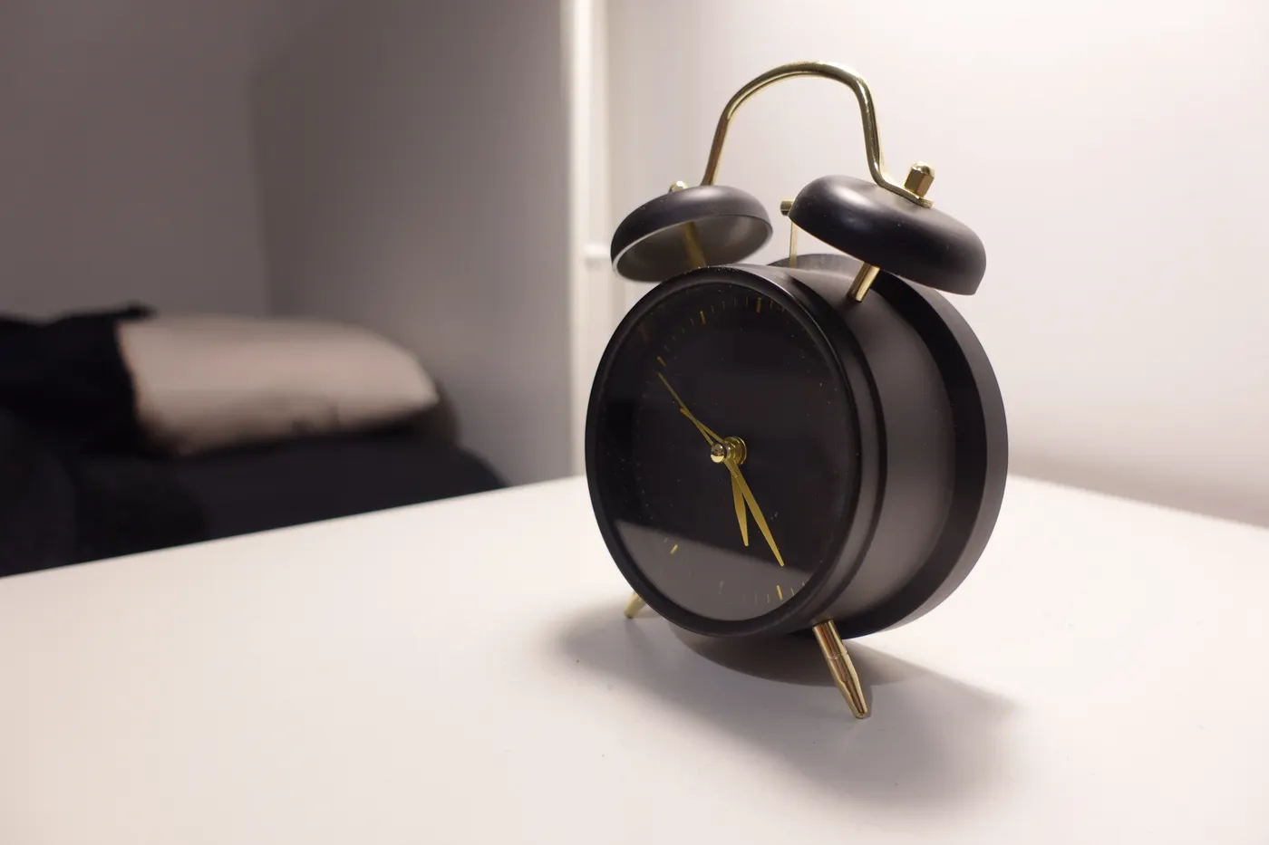 Vintage alarm clock on a quiet bedside table