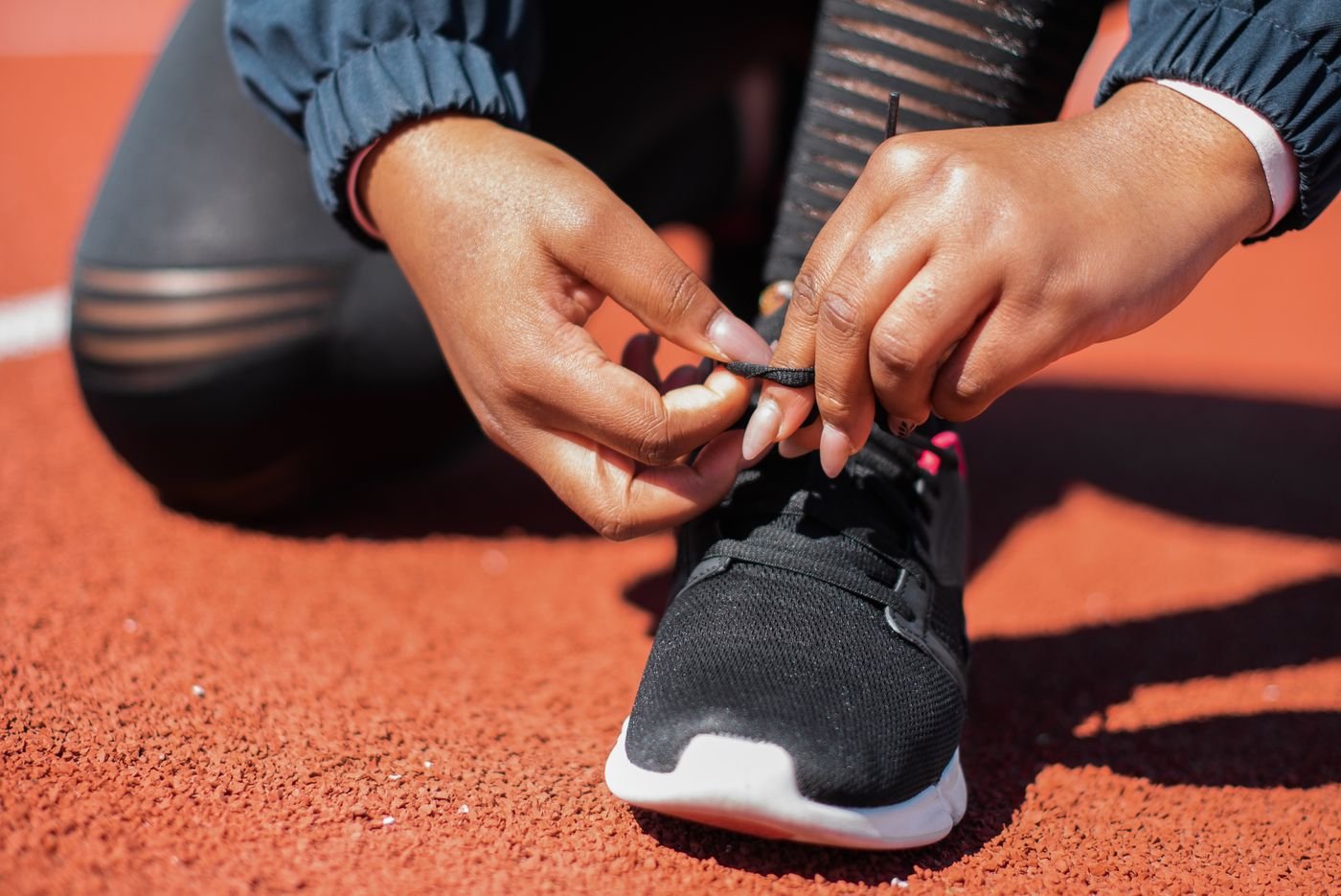Runner tying running shoes before a planned training session