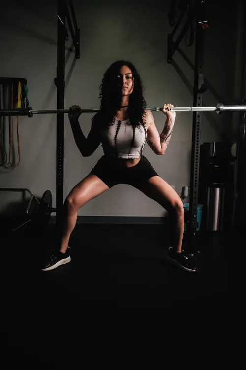 Woman lifting a barbell during strength training