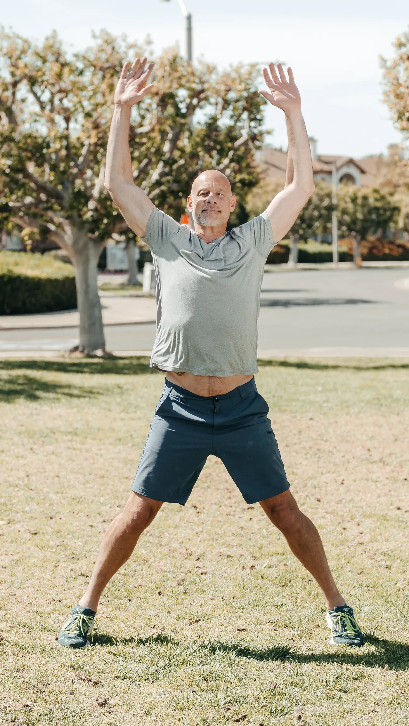 Older man doing jumping jacks