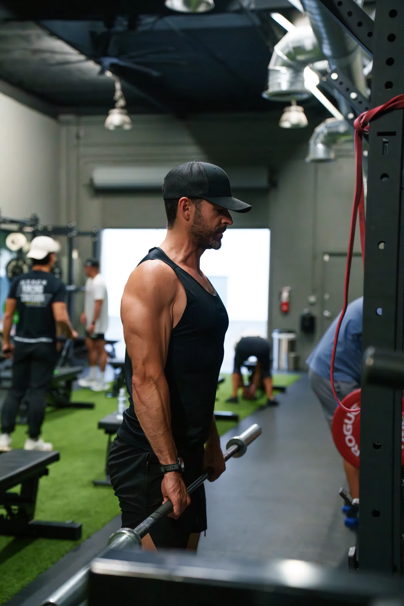 Athlete training with weights in a gym group session