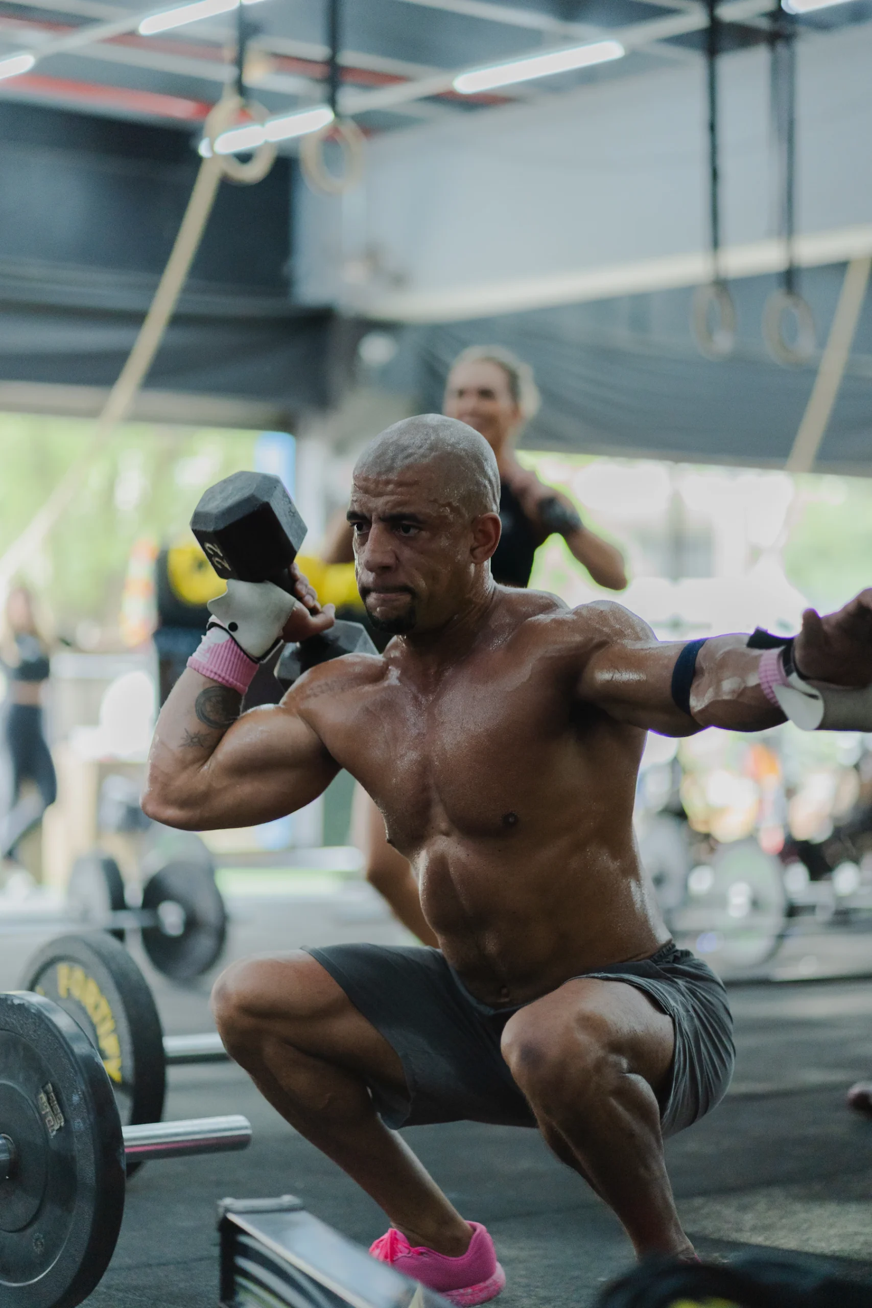 Lifter performing a dumbbell squat during a lower-body strength session