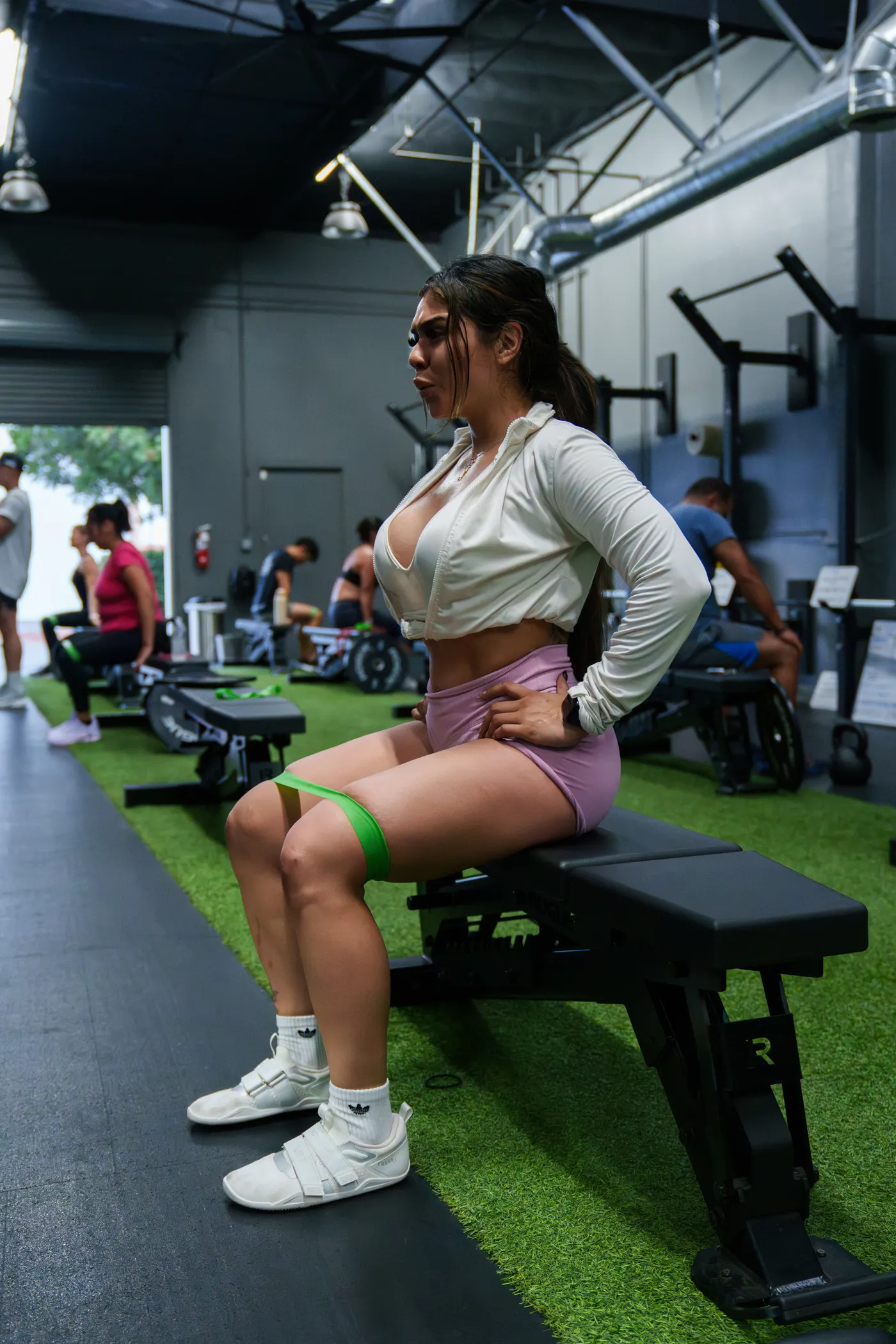 Woman training her legs with a resistance band in a gym