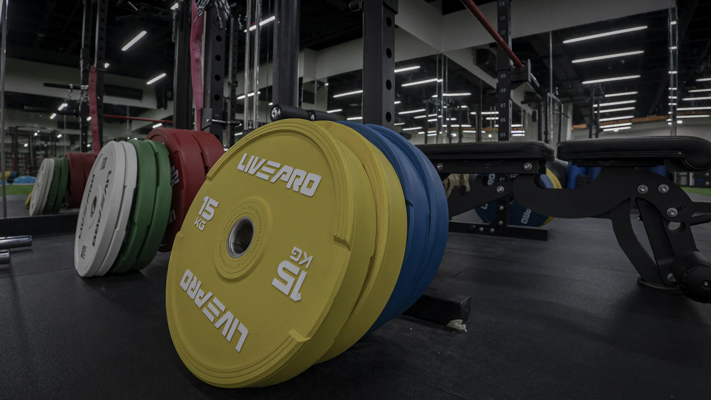 Colorful gym weight plates illustrating added external load