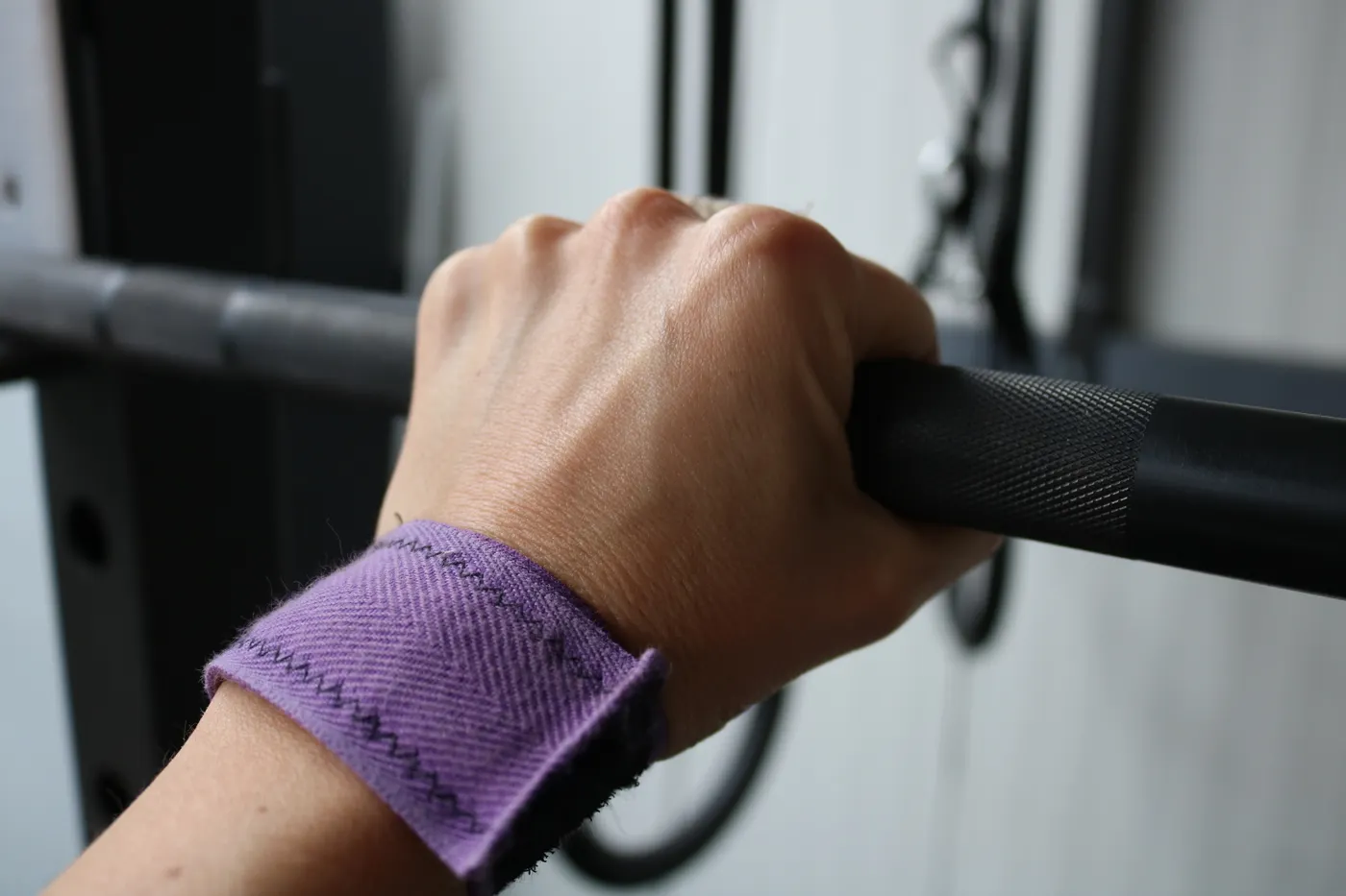 Hand gripping a barbell with the wrist aligned