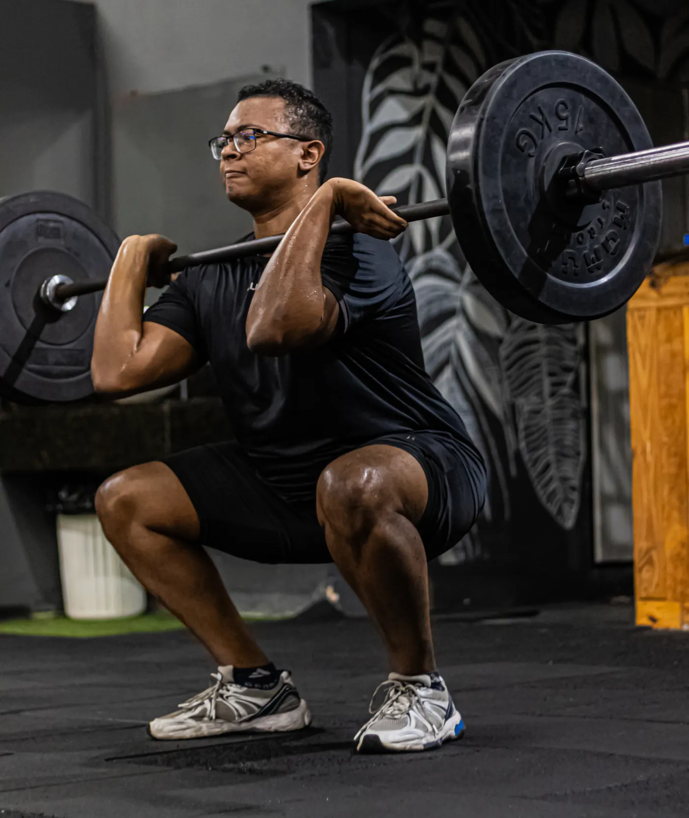 Man performing a barbell squat during a strength workout